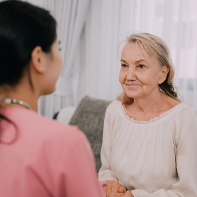 happy-senior-woman-talking-with-female-caregiver